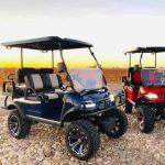 Two golf carts parked side by side on a sunny day, outdoor view